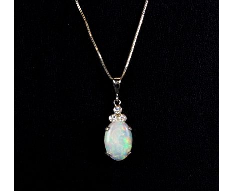 A white metal (tested 18ct gold) opal and diamond set pendant on an 18ct white gold chain, L. 3cm.