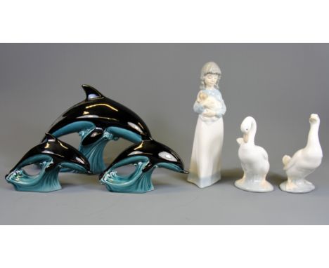 Three Nao figures and three Poole pottery dolphins.