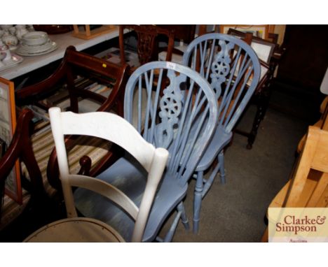 A pair of blue painted stick and wheel back chairs