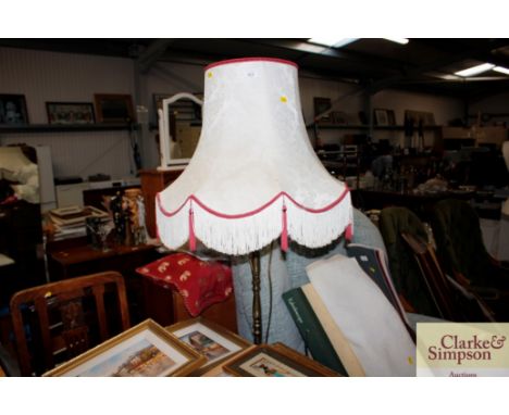 A brass standard lamp and shade