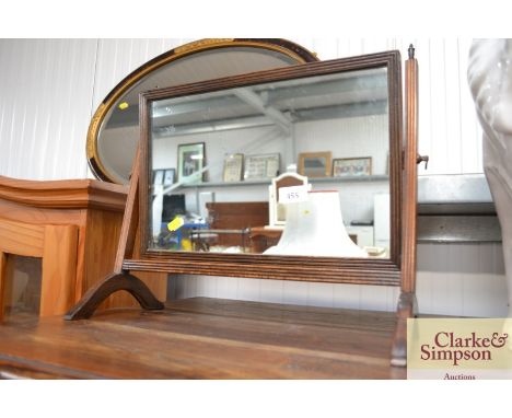 A swing framed toilet mirror