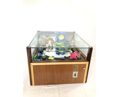 Fairground table model game machine featuring a large clock. Works with USA 25 cent coins (quarters). The mechanism looks goo