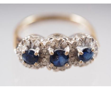 An 18ct gold three-stone sapphire and diamond ring, size G, 3.7g 