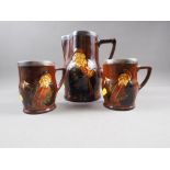 A Royal Doulton silver topped Charles Noke pitcher and a matching pair of tankards