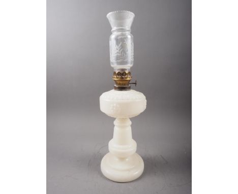 A late 19th century brass oil lamp with milk blue glass reservoir and etched glass floral design shade, on circular stepped b