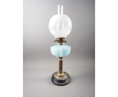A late 19th century brass oil lamp with milk blue glass reservoir and etched glass shade, on fluted column and circular stepp