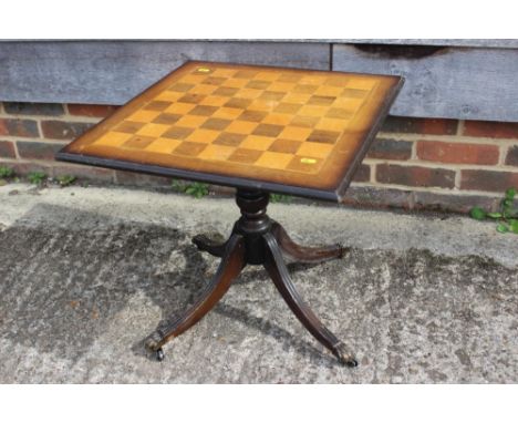 A walnut and birch low games table, on turned column and quadruple slay support, 20" square x 19" high, and a composition Isl