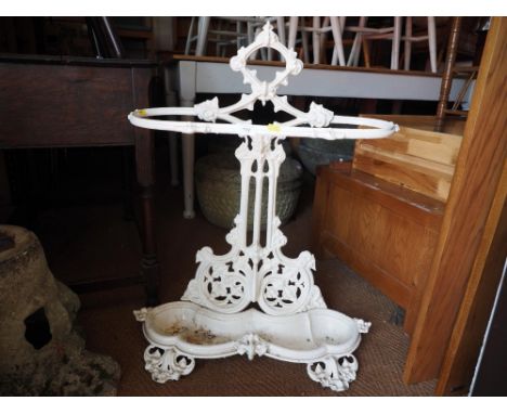 A white painted cast iron scrollwork stick stand, 30" high 