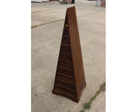 A pyramid shape chest of nine drawers with ring handles, on bracket feet, 20 1/2" wide x 18" deep x 58" high 