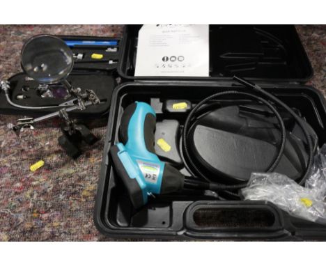 A Ring Automotive "Borescope" inspection camera, cased, an adjustable magnifying glass and a "Crewline" inspection light set,