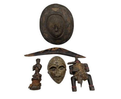 African carved wood shield, African wood mask, two African figures and an Aboriginal boomerang with decoration