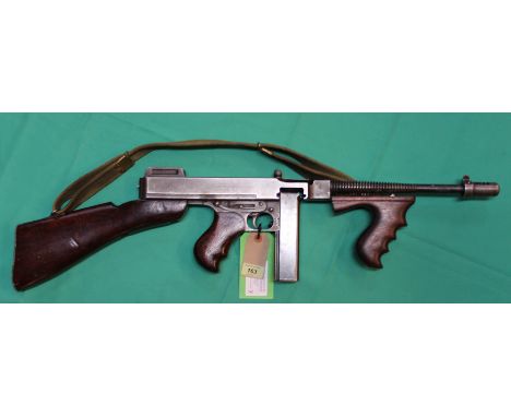 A .45 A.C.P. Thompson model 28AI sub-machine gun, with Cutts compensator Lyman sights and stick magazine, as well as original