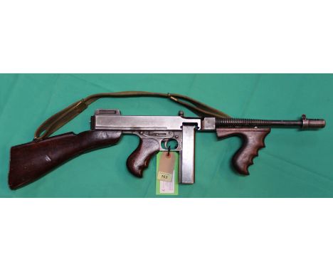 A .45 A.C.P. Thompson model 28AI sub-machine gun, with Cutts compensator Lyman sights and stick magazine, as well as original