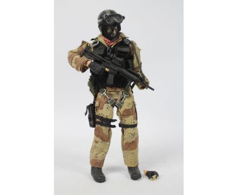 Blue Box - An unboxed 1:6 scale Blue Box Elite Force SFOD Delta Force action figure. The figure has a detached left hand, oth