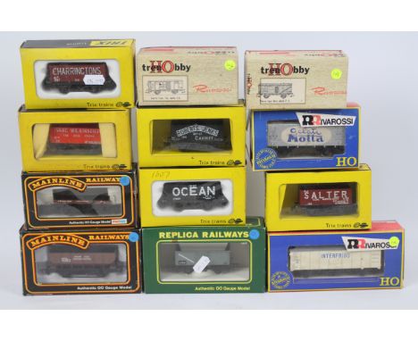 Trix - Mainline - Rivarossi - 12 x boxed OO gauge wagons including a 7 plank wagon in Isaac Wilkinson of Mytholmroyd livery #