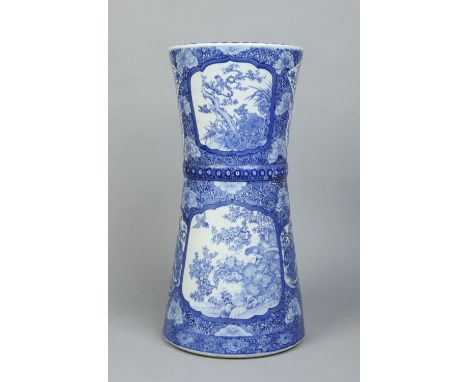 A Japanese Meiji period blue and white stick stand of cylindrical waisted form. Painted in underglaze blue with a ground of l