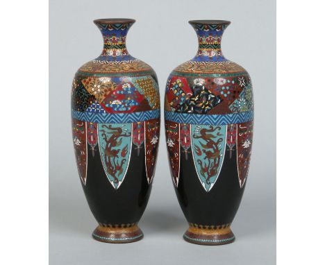 A pair of Japanese Meiji period cloisonne vases, black ground and decorated with stylized panels, 24cm. Condition Report. To 