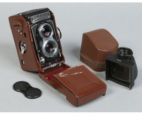 A cased Rolleiflex Type 3 TLR camera, model K8 serial No. 2186782, with built in light meter and cased Rollei eye level prism