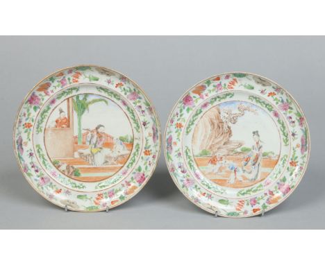A pair of early 19th century Cantonese plates. Finely potted and each enamelled with figures in landscapes under borders of f