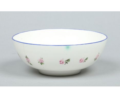A Nantgarw slop bowl. Edged with blue enamel rim and painted with a band of rose sprigs. Unmarked c.1820, 17.5cm diameter..  