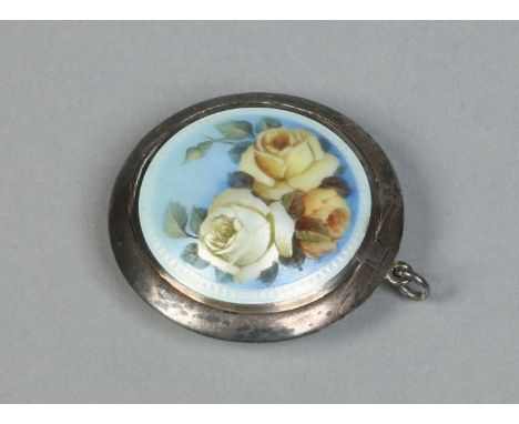 A continental silver powder compact. Decorated with engine turned engraved and enamelled panels, one side painted with yellow