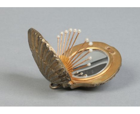 A French silver powder compact in the form of a scallop shell. Housing a mirror and a set of gold and seed pearl pins, 5cm wi