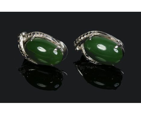 A pair of cabochon jade earrings mounted in white metal, stamped 8k.