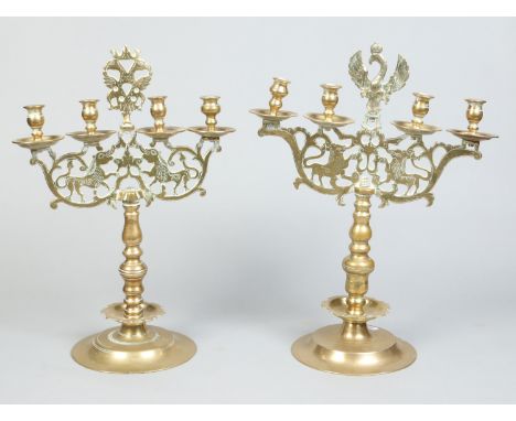 A matched pair of 18th century brass German four light candelabra, 57cm.