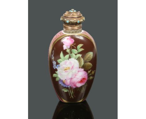 A 19th century French porcelain scent bottle painted with a panel of flowers over a pink and gilt ground. With gilt metal top