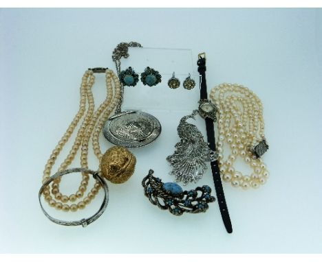 A Collection of costume jewellery, including a silver and marcasite cocktail watch, a silver hinged circular locket, the fron