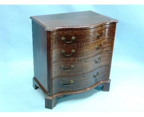 A George III-style mahogany serpentine Chest of Drawers, the shaped top with moulded edges above a slide and four long gradua