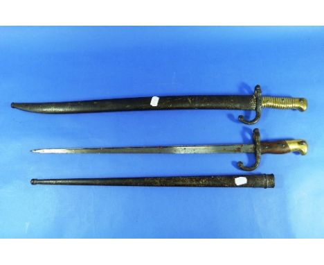 A French 1867 Chassepot Bayonet, the engraved blade dated, with scabbard, and a French Gras bayonet, the blade engraved and d