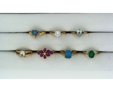 A collection of seven Rings, all from GemsTV Ltd., one oblong blue topaz, mounted in 9k yellow gold, one 9k ruby and diamond 