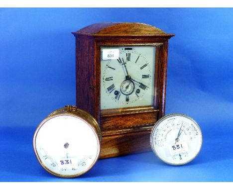 An early 20thC oak Mantel Clock with alarm, with square white dial and Roman numerals, arched inlaid case, the 8-day movement
