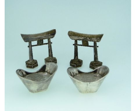 A pair of Yeching Sterling silver 'Pagoda' salt and pepper shakers, marked on the base 'Yeching Sterling', 2½in (6.25cm) wide