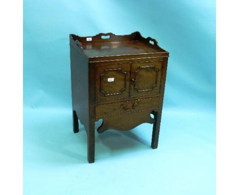 A George III mahogany tray-top beside Commode, the rectangular top with shaped gallery and pierced carry handles above a pair