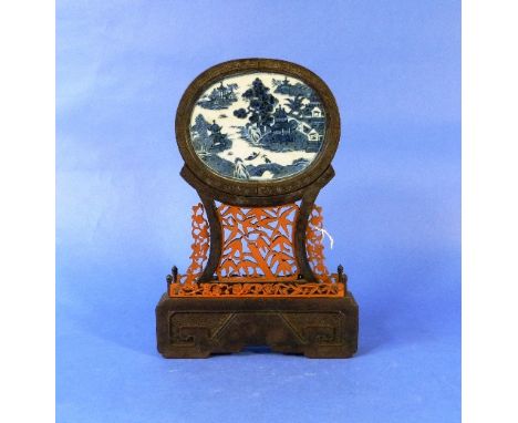 A 19thC Chinese Table Screen, the oval blue and white porcelain plaque decorated with the Willow pattern, the wooden frame wi