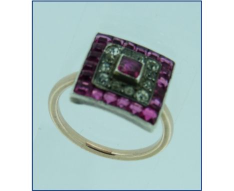 A dress Ring, composed of a square face with a centre pale calibre cut ruby surrounded by small diamonds and with an outer ro