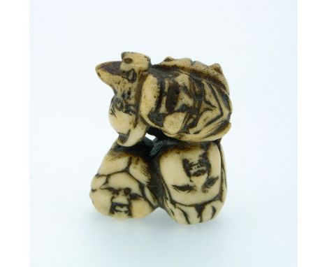 A 19thC Japanese carved ivory Netsuke, carved with seven various faces, 1¾in (4.5cm) high. THIS LOT WILL BE SOLD ON SATURDAY 