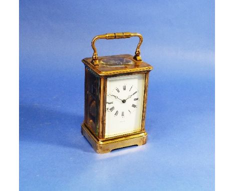 A French gilt brass Carriage Clock, with eight-day repeating movement striking the hours on a gong, the white dial signed 'Ba