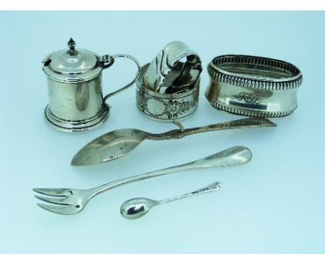 Seven small silver and silver-plated pieces, including a mustard pot, lacks liner, three napkin rings, pickle fork, preserve 