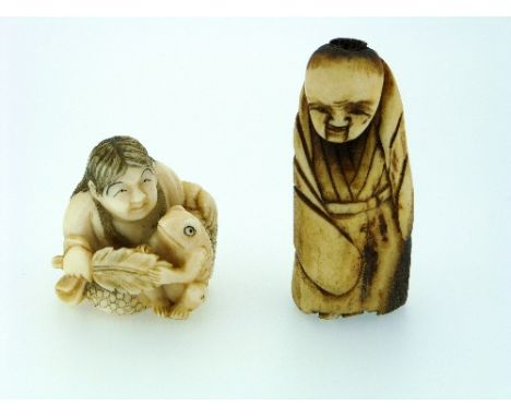 A 19thC Japanese ivory Netsuke, carved as a woman seated beside a frog, holding a leaf between them, red seal signature on ba