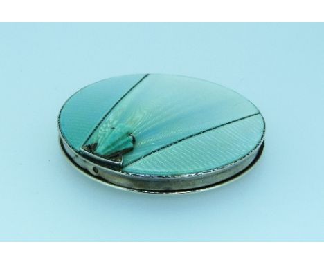 An Art Deco silver and enamel Compact, by Henry Clifford Davis, hallmarked Birmingham, 1939, the circular pale turquoise guil