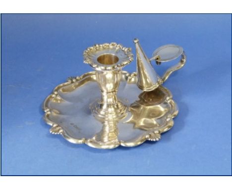 An Edwardian silver Chamber Stick, by Nathan & Hayes, hallmarked Chester, 1905, with snuffer, the shaped rim with scroll and 