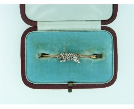 A bar Brooch, mounted with a diamond set charging boar, with two ruby eyes, mounted in white and yellow metal. THIS LOT WILL 
