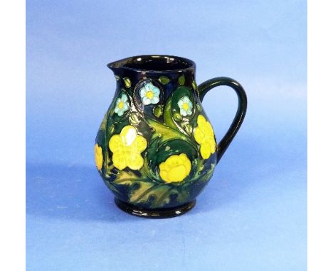 A Moorcroft 'Buttercup' pattern Jug, designed by Sally Tuffin, decorated with tubelined yellow and light blue flowers, all ag