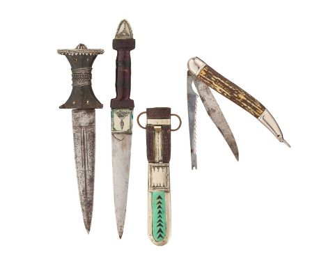 AN INDO PERSIAN DAGGER, A TUAREG DAGGER AND A FOLDING FISH KNIFE the first with double-edged blade, single fuller extending a