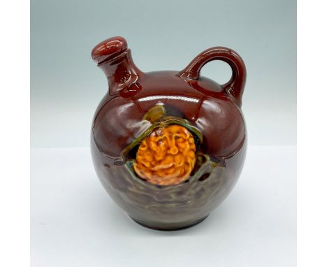 A brown glazed bottle with a ceramic stopper. Features a bearded fisherman in relief on one side, and fishing boats on the ot