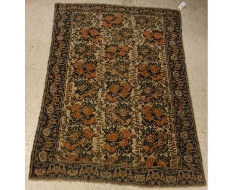 An Afshar rug, the central panel set with rose design on a cream ground, within a stepped blue, cream and terracotta floral d