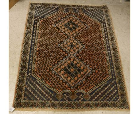 An Afshar rug, the central panel set with three diamonds on a lozenge shaped medallion with hook decoration, within a blue, s